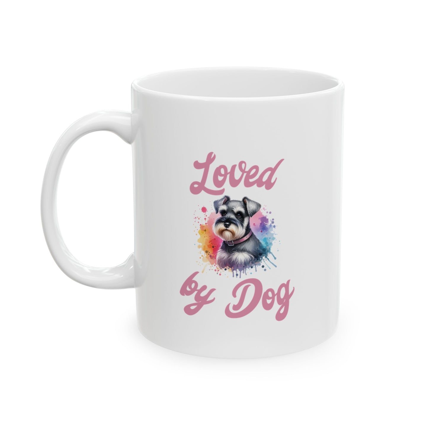 The D&B Apparel Miniature Schnauzer Ceramic Mug (11oz, 15oz) showcases a charming Schnauzer illustration with colorful splashes and Loved by Dog elegantly in pink above and below, making it an ideal choice for pet lovers.