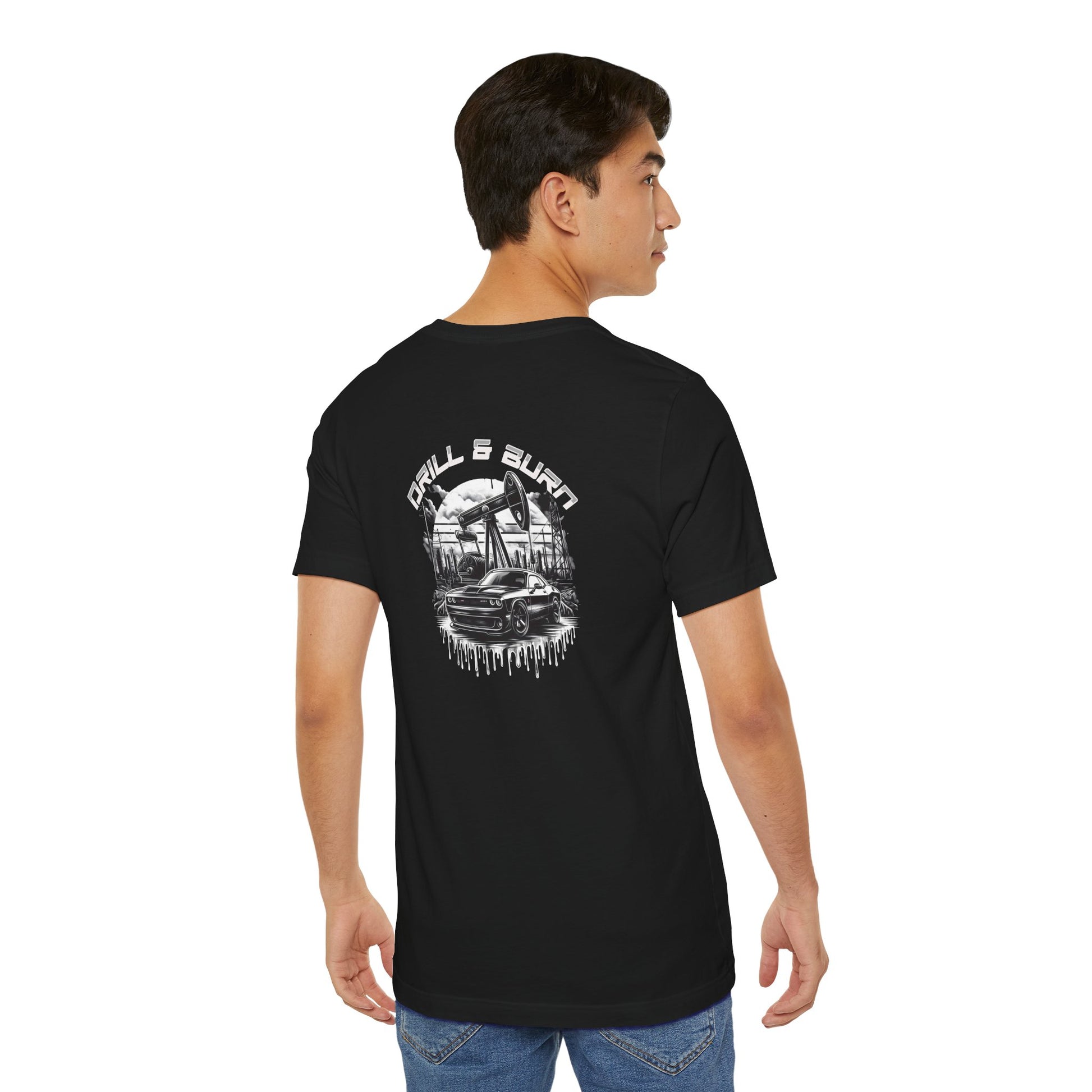 A young man faces away, wearing a black Vintage Car Graphic Unisex Tee by Printify, featuring a city scene graphic labeled Cool Car Art Design. Crafted from breathable fabric, he stands against a white background, casually resting his left hand by his jeans pocket.