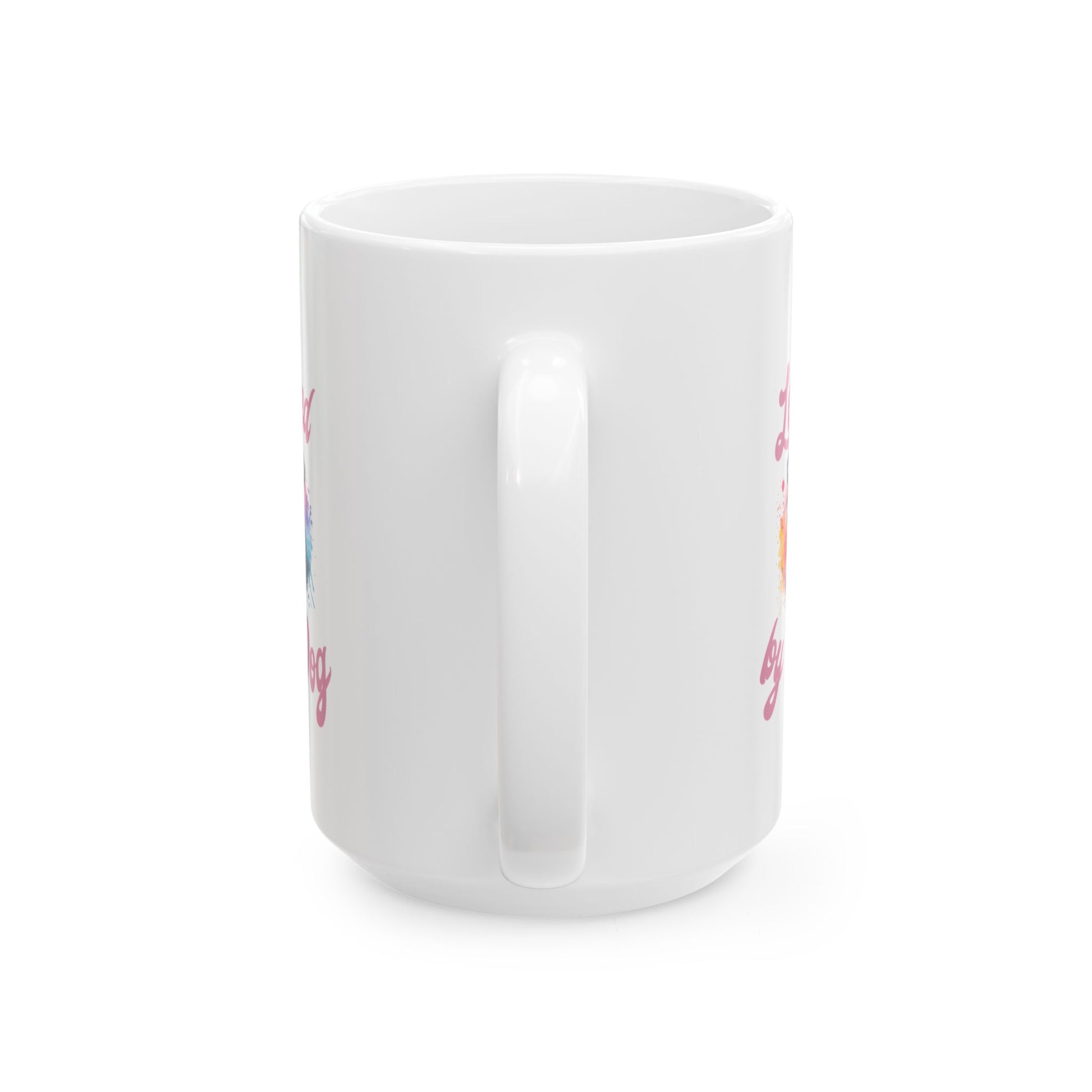 The Miniature Schnauzer Ceramic Mug by D&B Apparel is shown from the side, highlighting colorful text at the edges. Available in 11oz and 15oz, this white ceramic coffee mug with a handle adds a unique touch to your collection against a plain white background.