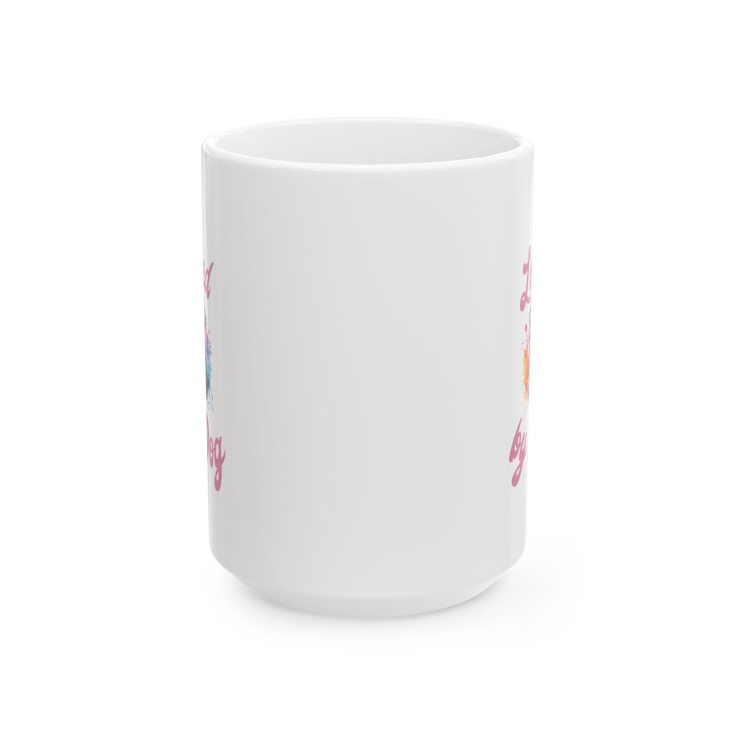 The D&B Apparel Miniature Schnauzer Ceramic Mug, available in 11oz and 15oz, features a white design with partially visible colorful elements and pink cursive text. It is shown from a side angle against a plain white background.