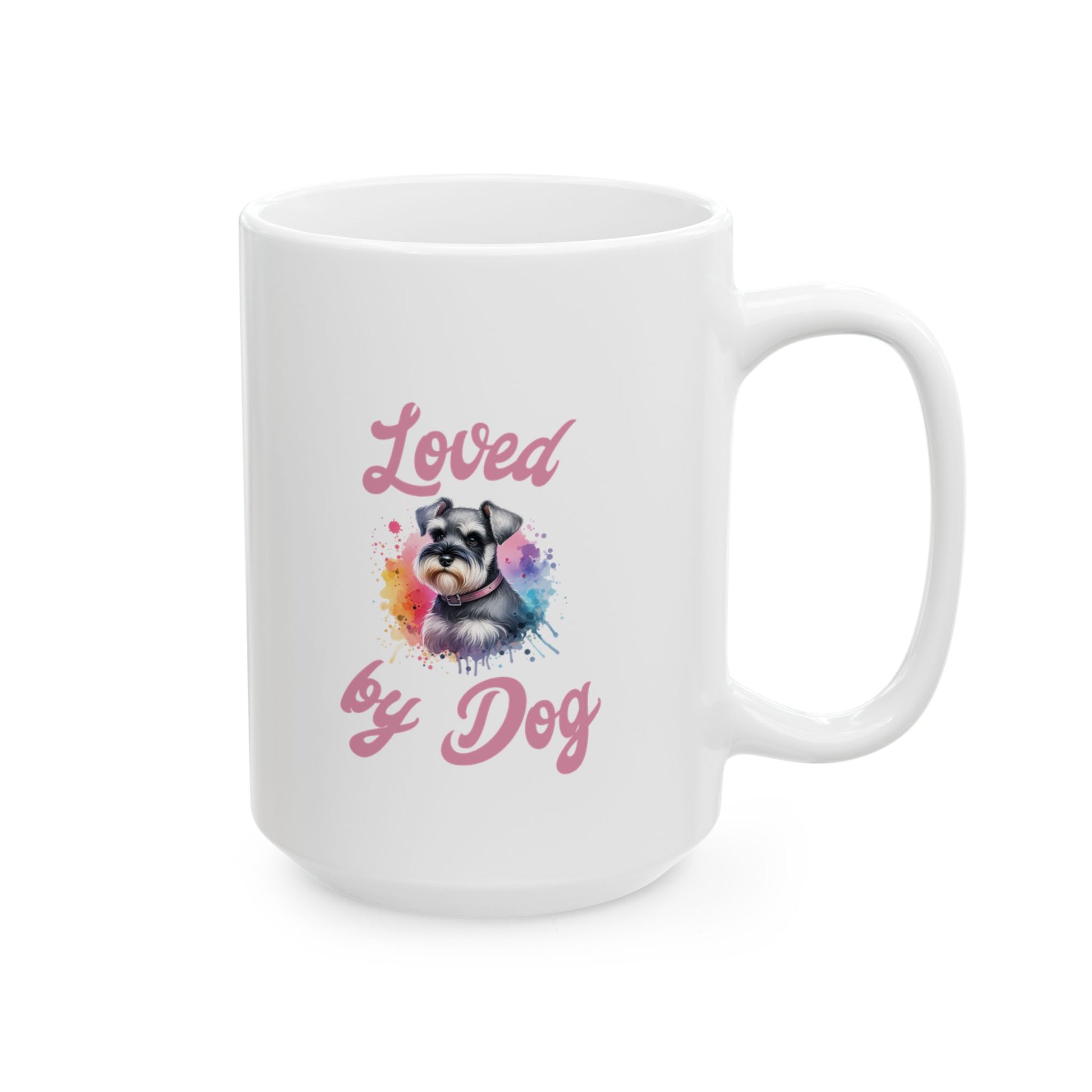 The D&B Apparel Miniature Schnauzer Ceramic Mug is a white, BPA-free coffee mug available in 11oz and 15oz sizes. It features a schnauzer illustration with colorful splashes and the phrase Loved by Dog in pink text.