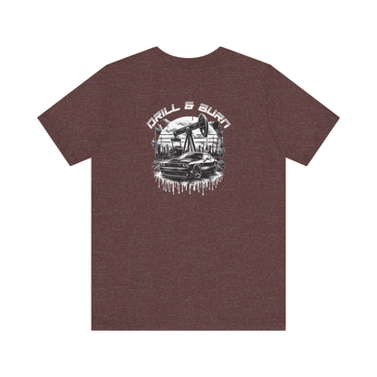 The Vintage Car Graphic Unisex Tee by Printify, featuring a breathable jersey fabric, displays an oil pumpjack and black car graphic with Drill & Burn in bold white letters, embodying casual fashion.